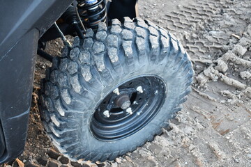 UTV tire in dirt. Isolated front end.