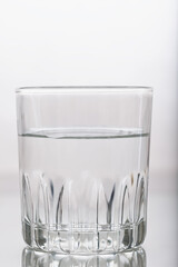 glass with still tap water , glass for alcohol on a white background. isolated object. Element for design