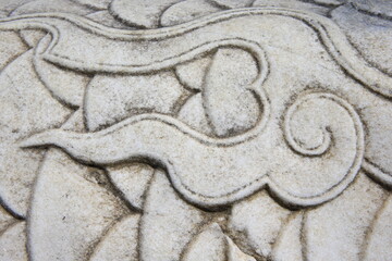 Vintage ornament on the stone. Close-up seamless texture. Stone texture. Embossed pattern.
