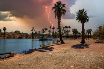 A gorgeous landscape at Papago Park with a lake, lush green palm trees and rocks in Phoenix Arizona USA