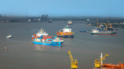 Cargo ship transporting containers on Saigon River from port to East Sea