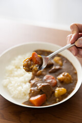 木製のテーブルの上に置かれた日本のカレーライス