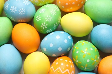Beautiful decorated Easter eggs on light background, top view