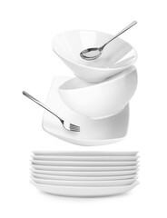 Clean dishware and silverware flying over stacked plates on white background