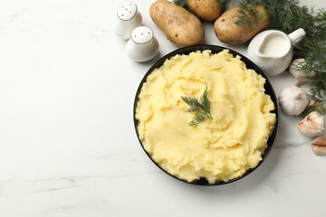 Delicious mashed potato with dill served on white marble table, flat lay. Space for text