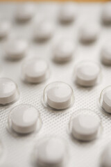 Close-up view of white medication tablets in a blister pack