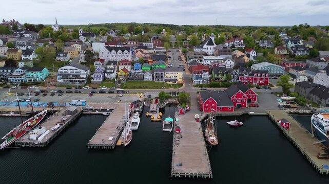 Aerial Footage Of The Historic Town Of Lunenburg, Nova Scotia, On A Cloudy Summer Day. The Scenic Coastal Views And Vibrant Buildings Showcase The Charm Of This UNESCO World Heritage Site.