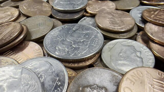 US coins close-up, panning over loose change