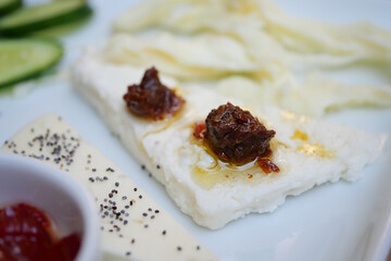 Savory white cheese with sundried tomatoes and veggies served