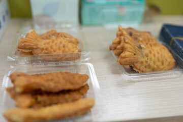 Taiyaki Japanese fish shaped pancake. Sweet waffles in the form of fish with different fillings
