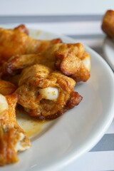 Spicy chicken wings served on a plate at a casual restaurant