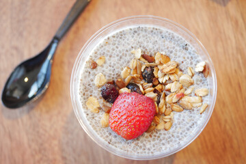 Chia pudding topped with granola and fresh strawberry dessert