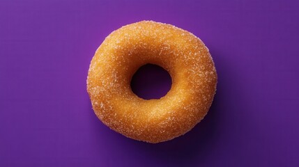 Top View of Sugared Donut Ring on Solid Vibrant Purple Background