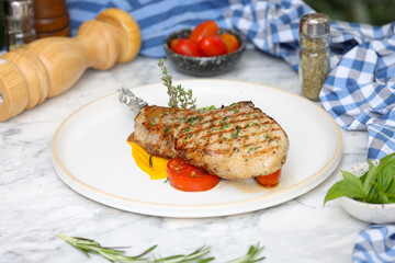 Culinary delight grilled pork chop with fresh vegetables at home
