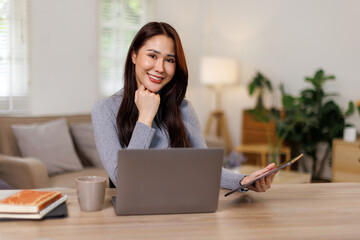 Busy beautiful professional business asian woman looking at laptop working in office
