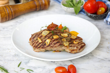 Grilled steak with garlic and vegetables kitchen food photography brightly lit close-up culinary art