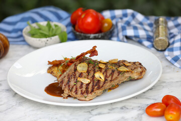 Close-up food photography grilled steak with tomato & almonds