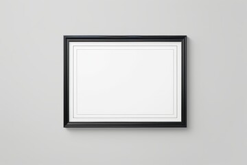 blank black picture frame on a wall with a white background