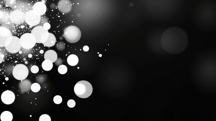 Abstract grayscale bokeh background with bright white and gray circles of varying sizes, scattered against a dark backdrop. The lights are
