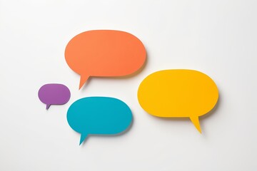 three colorful speech bubbles on a white surface with a shadow