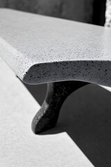Close-Up of a Modern Concrete Bench with Smooth Surface and Elegant Leg