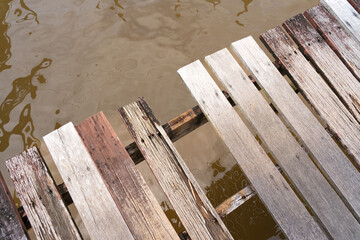 pedestrian bridge made of wood, with broken boards