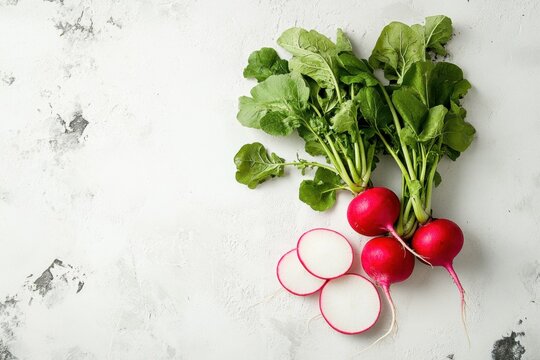 A bunch of radishes and greens are on a white background