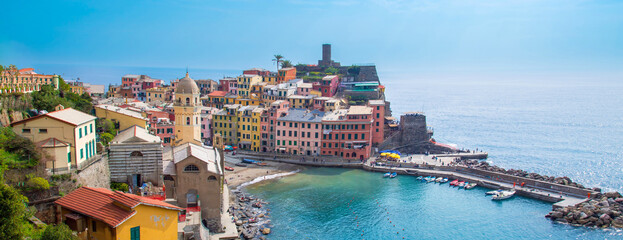 Cinque Terre, Italy, Scenic view of Vernazza shoreline and colorful buildings in a bay.