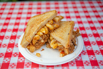 Gourmet Grilled Macaroni and Cheese Sandwich with Savory Filling on Checkered Table