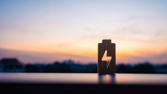 Technology battery high power electric energy with a connected charging cable. Battery to electric cars and mobile devices with clean electric, Green renewable energy battery storage future.