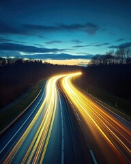 Obraz premium Night highway with light trails under a starry sky landscape photography capturing motion and speed with a dark forest background and a low angle view