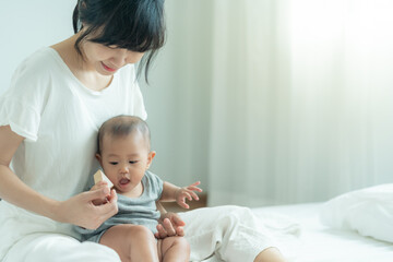 Happy Asia mother play and learn toy blocks with the little girl. Funny family is happy and excited in the house. Mother and daughter having fun spending time together. Holiday, Activity, development