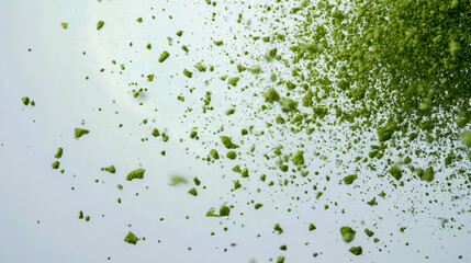 Many small green particles form the shape of on a blue background, high-resolution photography.