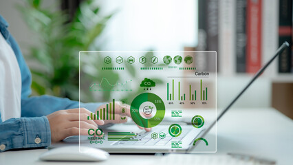 Businessmen use laptops to analyze ESG Co2 Carbon footprint Emission report graph to net zero....