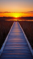 Obraz premium Sunset Over Calm Water as Wooden Path Leads Through Tall Grass at Evening
