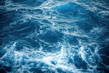 Obraz premium Abstract Texture Of Dark Blue Ocean Waves With Whitecaps, A Dynamic Marine Background Featuring Turbulent Water And Fluid Motion. The Image Captures
