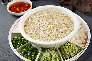 White porcelain bowl with grains, pea flour, rice and shrimp