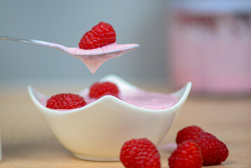 Dessert with raspberries in a spoon close-up, diet food