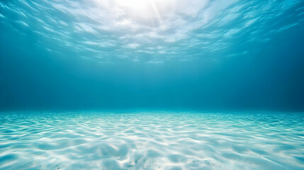 Underwater Scene With Bright Sunlight Penetrating Through Clear Blue Water With Sandy Seabed