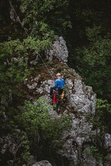 Fototapeta premium Climber ascending rocky cliff