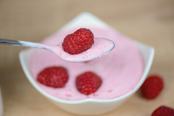 Dessert with raspberries in a spoon close-up, diet food