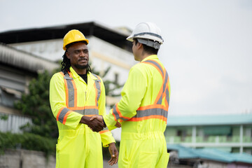African American engineer hand shake with Caucasian engineer at container site