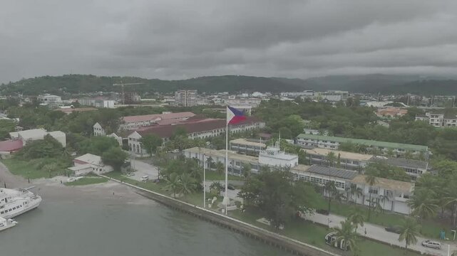 The Philippine flag at Subic Bay proudly flutters, showcasing its vibrant colors: a blue field representing peace.