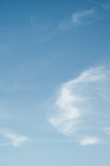 This photograph captures a breathtaking view of the blue sky adorned with soft, white clouds