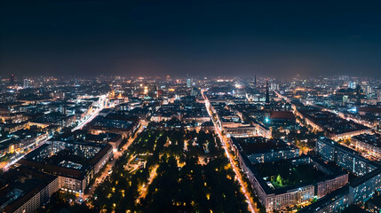 Obraz premium Aerial View Of Illuminated City Buildings and Streets at Night with Blue Dark Sky