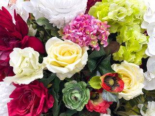 A bouquet of flowers with a mix of red, white, and green flowers