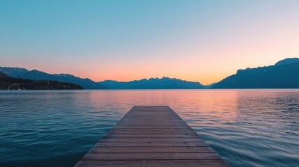 Obraz premium Dock extends over tranquil lake at dusk, mountains backdrop, clear horizon line