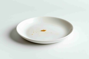 White Plate Featuring Few Food Crumbs On A White Surface