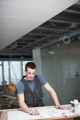 Designer, man or contractor drawing blueprint for drafting industrial architecture project at...