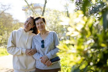 Naklejka premium Happy mother and daughter embracing in a sunny park